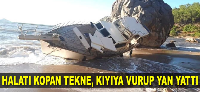 Antalya’da halatı kopan tekne, kıyıya vurup yan yattı