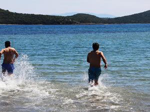 Bodrum'da gençler sahili boş görünce dayanamayıp denize girdi