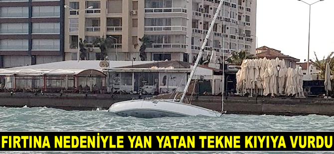 Çeşme'de fırtına nedeniyle yan yatan tekne kıyıya vurdu